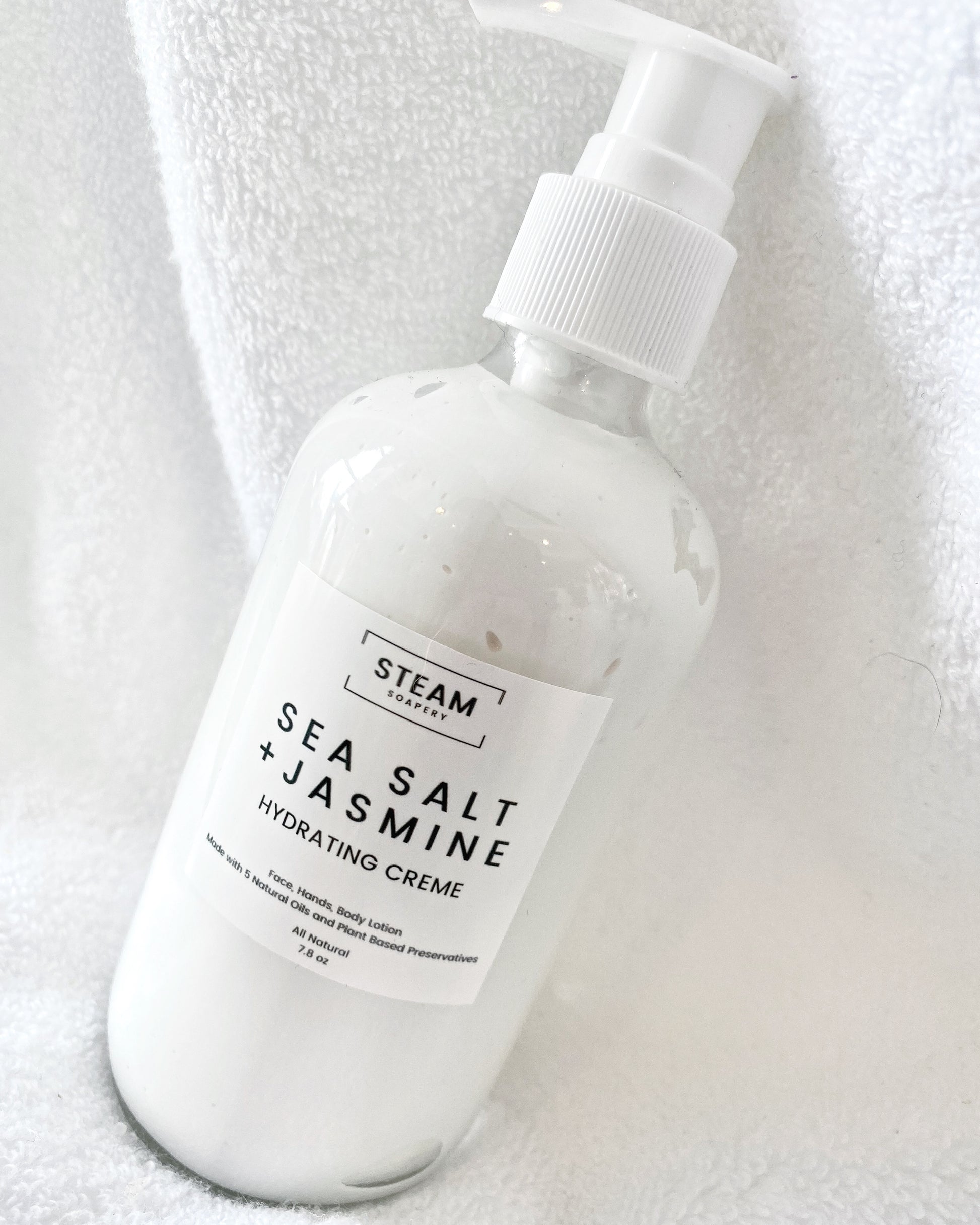 An 8oz Pump of our Sea Salt Jasmine Hydrating Creme in a Glass Bottle